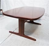 Lot 578:  Danish Modern Rosewood Dining Table. Oval Top with skirt. Trestle base with stretcher. Two 20" leaves: Dimensions:  H: 28.75 inches: W: 65 inches: D: 42 inches --- 