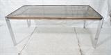 Lot 582:  70's Modern Chrome & Glass Dining Table. Large Dining Table with flat chrome frame. Inset smoked glass top.: Dimensions:  H: 28 inches: W: 72 inches: D: 39 inches --- 