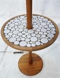 Lot 588:  MARTZ Walnut Lamp Table. Round table top with Martz glazed ceramic tile mosaic. Marshall studios wood finial. Marshall studio label.: Dimensions:  H: 60 inches: W: 15.5 inches --- 