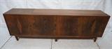 Lot 594:  Large Oversized Walnut American Modern Credenza Sideboard. Four spring loaded door buffet. Interior has drawers and shelves.: Dimensions:  H: 31 inches: W: 96 inches: D: 18 inches --- 