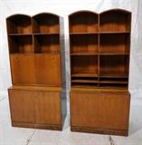 Lot 595:  Pr ROMWEBER American Modern Rosewood & Walnut Bookcase Cabinets. Double arched tops. 1. Cabinet has drop down desk over open shelves. Fitted interior. 2. Cabinet has open shelves over two doors. Each is a two part cabinet.: Dimensions:  H: 76 inches: W: 35.5 inches: D: 20.5 inches --- 