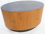Lot 641:  Adrian Pearsall style Side Table. Oval drum form with wood veneer. Black laminate top. Black wrapped vinyl base skirt. : Dimensions:  H: 20 inches: W: 30 inches: D: 20 inches --- 