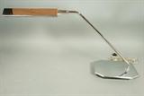 Lot 671:  KOCH & LOWY Chrome Desk Table Lamp. Shaped chrome shade on swivel arm.: Dimensions:  H: 15 inches: W: 28 inches: D: 7 inches --- 