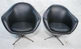 Lot 694:  Pr Overman Black Vinyl Lounge Chairs. Swivel. Chrome Pedestal Legs & Feet: Dimensions:  H: 32 inches: W: 33 inches: D: 26 inches --- 