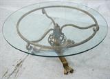 Lot 703:  Glass Top Iron Base Coffee Table. Decorator Gold Gilt Wrought Iron.: Dimensions:  H: 17 inches: W: 36 inches: D: 36 inches --- 