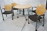 Lot 741:  Blond Wood Round Dining Table & 4 Chairs. Metal table base. Four arm chairs marked HAYWORTH. Table & Chairs have casters and roll.: Dimensions:  H: 29 inches: W: 42 inches: D: 42 inches --- 