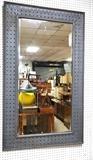 Lot 743:  Large Industrial Steel Wall Mirror. Wide Perforated Steel Frame on beveled mirror. Riveted trim.: Dimensions:  H: 59 inches: W: 35.5 inches --- 