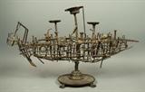 Lot 748:  Brutalist Nail Ship Sculpture. Decorated with cartridges, washers and springs. On heavy metal footed base.: Dimensions:  H: 18 inches: W: 31 inches: D: 11 inches --- 