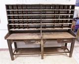 Lot 757:  Large 2pc Industrial Mail  Postal Unit. Long Rustic wood table. Compartments with destination labels. Chicken wire back. : Dimensions:  H: 68.5 inches: W: 84 inches: D: 22.5 inches --- 