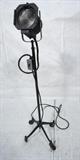 Lot 770:  Vintage Industrial Stage Light. Adjustable height. Four feet with wheels: Dimensions:  H: 60 inches: W: 15 inches --- 