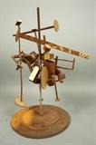 Lot 777:  Industrial Welded Iron Kinetic Table Sculpture. Rusted Geometric elements on rods. Paint and gilt highlights. Whole sculpture can spin. TERRY LEE DILL, sculptor.: Dimensions:  H: 22 inches: W: 19 inches: D: 12 inches --- 
