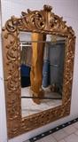 Lot 783:  Large Oversized Decorator Gilt Wall Mirror. Fancy "Carved" Frame with Scroll Pediment Top. Composition material.: Dimensions:  H: 91 inches: W: 59 inches --- 