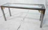 Lot 797:  Chrome & Glass Decorator Console Hall Table. Brass Corner Accents. Heavy chrome construction. Inset beveled glass top. : Dimensions:  H: 27.75 inches: W: 60 inches: D: 18 inches --- 