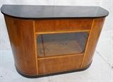 Lot 838:  Art Deco Bar with Display. Curved sides with glass area. Fitted back. Black laminate top.: Dimensions:  H: 40 inches: W: 60 inches: D: 21 inches --- 