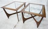 Lot 844:  Pr American Modern Glass Top End Tables. "X" Base stretchers with brass accent.: Dimensions:  H: 19 inches: W: 30 inches: D: 23 inches --- 