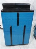 Lot 846:  Art Deco Blue Wood Dental Medical Cabinet. Black trim & accents. Lift Top. Eleven drawers. Chrome Base Rim. American Cabinet Co. : Dimensions:  H: 48 inches: W: 28 inches: D: 14 inches --- 