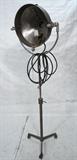 Lot 851:  Large Tall Industrial Movie Film Spot Light. Steel frame on tripod base on wheels. Adjustable.  Marked HDS; Hollywood Scene Dock. : Dimensions:  H: 81 inches: W: 28 inches: D: 21 inches --- 