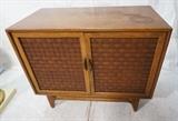 Lot 875:   "Woven" Front 2 door Cabinet. Walnut American Modern Stretcher Base.: Dimensions:  H: 30 inches: W: 36 inches: D: 19 inches --- 