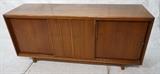 Lot 881:  American Modern 3 Door Credenza. One sliding door with vertical trim detail. Fitted interior. CAVALIER Furniture fabric label. : Dimensions:  H: 34 inches: W: 72 inches: D: 21 inches --- 