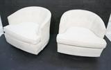 Lot 904:  Pr Milo Baughman Style White Barrel Back Club Lounge Chairs. Ebonized Black Swivel Base.: Dimensions:  H: 26 inches: W: 31 inches: D: 31 inches --- 
