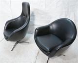 Lot 907:  2pc OVERMAN Black Lounge Chairs. One high back; one low back. Chrome pedestal bases: Dimensions:  H: 41 inches: W: 32 inches: D: 31 inches --- 