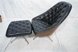Lot 908:  THAYER COGGIN  Milo Baughman Lounge Chair. Ottoman. Tufted Black leather. Molded wood shell barrel back. Chrome pedestal bases.  Coggin label. : Dimensions:  H: 36 inches: W: 29 inches: D: 32 inches --- 