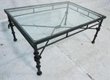 Lot 909:  BAKER & KNAPP  Wrought Iron Coffee Table.  Giacometti Series. Glass top on sculpted metal base cocktail table. : Dimensions:  H: 18 inches: W: 40 inches: D: 28 inches --- 