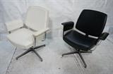 Lot 918:  Pr 70's Chrome Arm Lounge Chairs. Black & White Leather. Swivel pedestal bases. Floating upholstered arms. : Dimensions:  H: 36 inches: W: 29 inches: D: 22 inches --- 