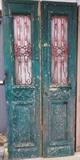 Lot 924:  Pr Green French style Antique Wood Doors. Inset fancy iron panels. Doors and iron painted. : Dimensions:  H: 93 inches: W: 21.5 inches --- 