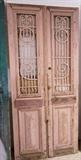 Lot 925:  Pr Pink French style Antique Wood Doors. Inset fancy iron panels. Doors and iron painted. : Dimensions:  H: 93 inches: W: 21.5 inches --- 