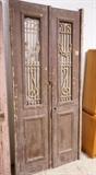 Lot 926:  Pr Brown French style Antique Wood Doors. Inset fancy iron panels. Doors and iron painted. : Dimensions:  H: 96 inches: W: 21.5 inches --- 