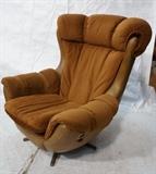 Lot 934:  Oversized Overman Style Lounge Chair.  Vinyl and Ultra Suede.  Swivel and rock.  Buckle sides.: Dimensions:  H: 41 inches: W: 36 inches: D: 37 inches --- 