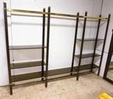 Lot 938:  Large Metal and Glass Etagere wall Unit.  Smoked glass shelves.  Two tone brass uprights.: Dimensions:  H: 83 inches: W: 114 inches: D: 14 inches --- 