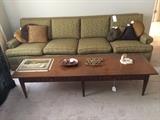 Long 1960's 4 person sofa in excellent condition flanked by mint 6 foot Bassett coffee table 