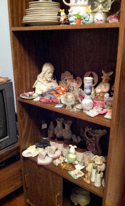 bookcase with misc figurines and glassware