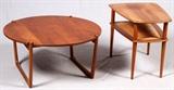 Lot#21, 'FRANCE & SON', DANISH, MID CENTURY MODERN TABLES, C. 1950, TWO, H 17" & 23", PETER HVIDT.Including one teak side table, designed by Peter Hvidt and Orla Molgaard Nielson for France & Son, fitted with a lower cane paneled shelf, and raised on tapered legs, measuring H. 23" x 27" x 20 1/2"; together with one teak coffee table, a two part construction with a round form top and base, measuring H. 17 1/2" x 35 1/2". Both feature the France & Son label at the underside, circa 1950s.