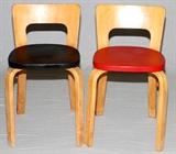 Lot#23, ALVAR AALTO STYLE LAMINATED WOOD CHILD'S CHAIRS, PAIR H 25"In the style of Alvar Aalto, two child's chairs, including one with a black seat, the other a red. Unmarked, measuring H. 25" x 16" x 15". Circa 1940-1960.