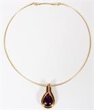 Lot#37, AMETHYST & 18KT YELLOW GOLD, PENDANT NECKLACE, L 18"Italian 18kt yellow gold lady's necklace, featuring a pear shaped amethyst, bezel set at the center of pendant, with round channel side diamonds above. Chain measures L. 18", with the pendant measuring L. 1 5/8" x 7/8", having a total approximate weight of 26.4 grams.