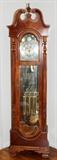 Lot#81, RIDGWAY MAHOGANY GRANDFATHER CLOCK, H 87", W 24", D 14"Swan-neck pediment centered by a urn-form finial, above a moon phase dial.  With a pendulum and three weights.
