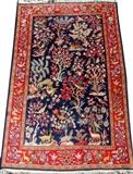 Lot#113, KASHAN WOOL RUG, W 3' 7", L 5' 8"Having a central blue ground with flowers, birds and deer surrounded by a red border with flowers and deer.