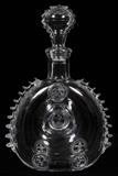 Lot#221, BACCARAT FRENCH CRYSTAL DECANTER, H 11", W 6"Round form decanter with indented center, decorated in fleur de lis motif. Acid etch marked at the underside, measuring H. 10 3/4" x 6 1/2".