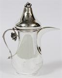 Lot#1023,TURKISH .900 SILVER INDIVIDUAL COFFEE POT, H 7 3/4"Pear-form body with elongated spout opposite a scroll handle with leaf terminal, having a hinged lid with berry finial; hallmarks underneath (see additional photo).  Weighs approximately 9.3 troy oz.  Early-mid 20th century.