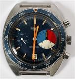 Lot#1060, HEUER VINTAGE GENTLEMAN'S 'SKIPPER' AUTOMATIC CHRONOGRAPH, C. 1972.Stainless steel with a deep blue dial, bright orange hands, seconds dial, date and fifteen minute countdown dial all on a blue face.  Serial number 263476 (see additional photo).  Replacement metal band.