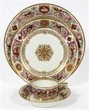 Lot#1064, SEVRES LOUIS PHILIPPE PORCELAIN LUNCHEON SET, C. 1846, 55 PIECES, CHATEAU OF FONTAINEBLEAU.Including 19 luncheon plates at 9 3/8",  12 salad plates at 7 3/4", 12 teacups, and 12 saucers. Each is decorated in arabesques of foliage with animal figures intertwined, separated by oval and diamond reserves of emblems and the royal cipher about the borders. Luncheon plates feature the crowned sunburst Chateau de F.Bleau mark, with the crowned 'LP' monogram mark in blue. The salad plates are marked at the underside with crossed arrows in blue, and the teacups/saucers are unmarked.  Circa 1839 to 1847.