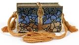 Lot#1166, JUDITH LEIBER BELTED BOOKS MINAUDIERE, W 5 1/2"In the form of three strapped books with multicolor full bead decoration in a stained glass style floral motif, blue cabochon push button opens to gold leather lining, coin purse, mirror and comb. Stamped: Judith Leiber, New York. Measures W.5 1/2" x 2 1/2" x 3 1/4" (23" to the detachable gold braided shoulder strap).