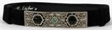 Lot#1173, JUDITH LEIBER BLACK SUEDE BELT WITH AN ART DECO STYLE BUCKLE. A black suede adjustable belt with a marcasite buckle in the art deco style and set with three cabochon stones of black and green, W.4 1/2" x 1 1/8".  Stamped: Judith Leiber.