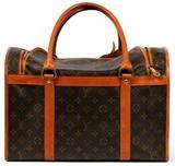 Lot#1187, LOUIS VUITTON MONOGRAM CANVAS DOG CARRIER, W 15 1/2"Tan leather trim and handles, zippered top and roll-up side (see additional photo), with lock and luggage tag.  Labeled: Louis Vuitton, Paris, Made in France.  Measures W.15 1/2" x 8 1/4" x 10 3/4" (17" to the double handles).