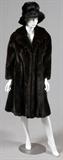 Lot#1199, L. STEINBACH LADY'S MINK COAT & HAT, VINTAGE, H 43" W 22", NEW YORK/Including one lady's dark brown mink fur coat, lined in patterned silk, and retailed by L. Steinbach New York, measuring H. 43" x 22", with the shoulder to sleeve at L. 27"; together with one mink fur wide-rimmed lady's hat, measuring W. 14". Vintage.