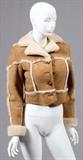 Lot#1210, LADY'S SHEARLING JACKET, H 18" W 18"Fitted with four pockets, and an open pocket at each side. Labeled: Ardney Collection at the interior. The jacket measures H. 18" x 18", L. 23" to the shoulder.