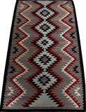 Lot#1301, NAVAJO EYE DAZZLER RUG, 5' 2" X 2' 10"In shades of black, red, cream and gray.  Mid 20th century.